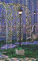 Lamp Post Illuminate your romantic garden with this exquisite lamp post. The 7' high x 1' wide plastic lamp post features intricate detailing and corrugated "granite" base. Plug it in to illuminate. Trellis Set Journey into a gorgeous garden when you step through this breathtaking entrance. Three 8' high x 5' wide metal trellises are covered with romantic ivy and twinkle lights