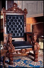 ornate, fit-for-a-king piece will be the crowning glory of any room! - very masculine tradition of English antiques. Its immense claw feet rise, flanked by winged creatures and regal sentinels, in high relief. The leather, cushioned seat spans a full yard (room for two!), while the stately back stands almost 6 feet high,