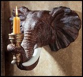 Add the flicker of candlelight to sculpture with our sconce that pays tribute to one of nature’s most splendid creatures. Our elephant sculpture is fraught with realistic details, from its soulful eyes to its trunk curled around the torch designed to hold your taper candle. 